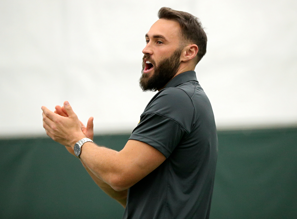 Iowa’s assistant coach Lloyd Bruce-Burgess claps as he urges on his players on during a singles match at the Hawkeye Tennis and Recreation Complex in Iowa City on Friday, February 14, 2020. (Stephen Mally/hawkeyesports.com)