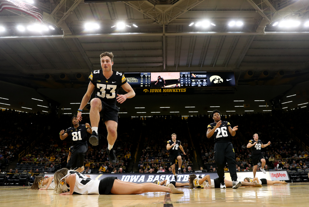 Members of the Hawkeye Football team performs with the Iowa Dance Team at halftime of the Iowa Hawkeyes game against the Ohio State Buckeyes Thursday, February 20, 2020 at Carver-Hawkeye Arena. (Brian Ray/hawkeyesports.com)