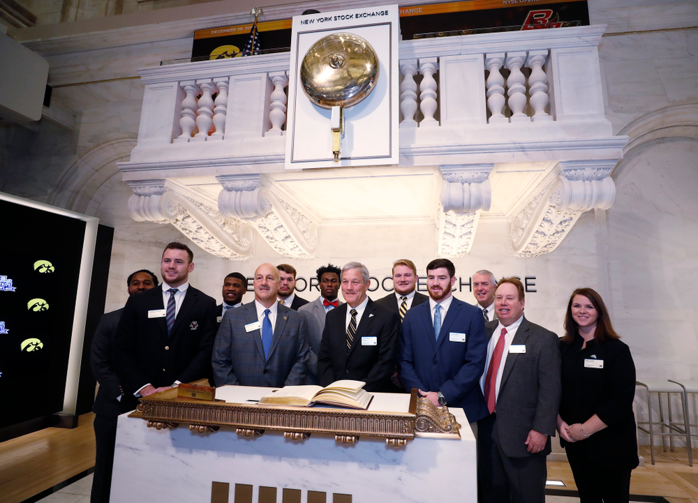 Iowa Hawkeyes linebacker Josey Jewell (43), defensive back Joshua Jackson (15), offensive lineman Sean Welsh (79) and head coach Kirk Ferentz ring the opening bell at the New York Stock Exchange Tuesday, December 26, 2017 in New York. (Brian Ray/hawkeyesports.com)