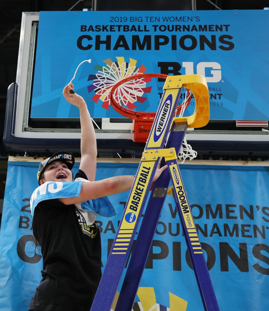 Iowa Hawkeyes forward Hannah Stewart (21) cuts down the net as they celebrate their victory over the Maryland Terrapins in the Big Ten Championship Game Sunday, March 10, 2019 at Bankers Life Fieldhouse in Indianapolis, Ind. (Brian Ray/hawkeyesports.com)