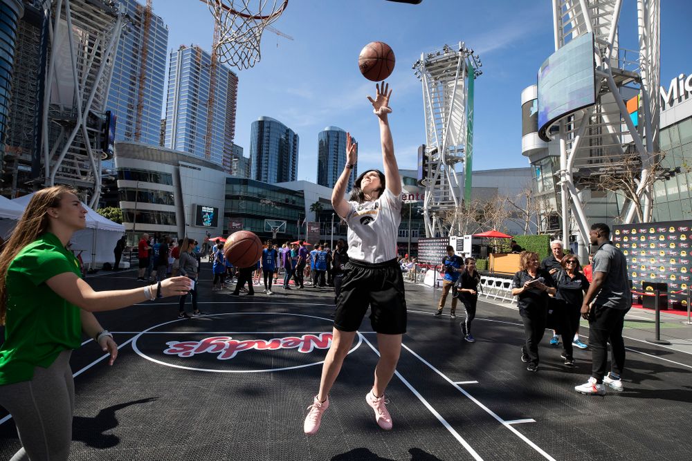 Iowa Hawkeyes forward Megan Gustafson (10) shoots baskets with OregonÕs Sabrina Ionescu before a Special Olympics event Friday, April 12, 2019 as part of the ESPN College Basketball Awards in the XBOX Plaza at LA Live. (Brian Ray/hawkeyesports.com)