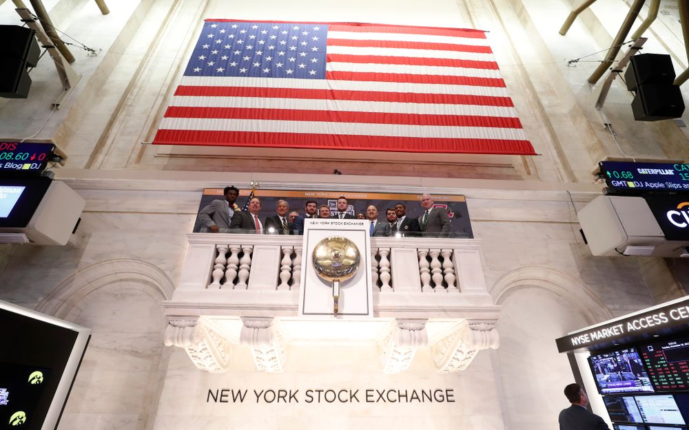 Iowa Hawkeyes linebacker Josey Jewell (43), defensive back Joshua Jackson (15), offensive lineman Sean Welsh (79) and head coach Kirk Ferentz ring the opening bell at the New York Stock Exchange Tuesday, December 26, 2017 in New York. (Brian Ray/hawkeyesports.com)