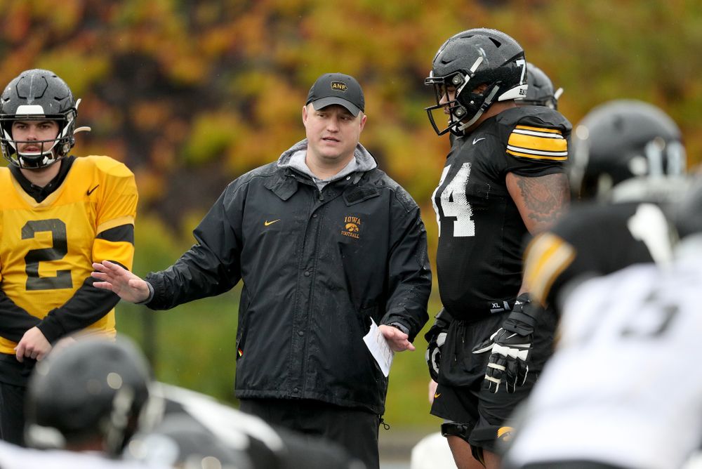 Iowa Hawkeyes offensive coordinator Brian Ferentz talks with offensive lineman Tristan Wirfs (74) during practice Monday, December 23, 2019 at Mesa College in San Diego. (Brian Ray/hawkeyesports.com)
