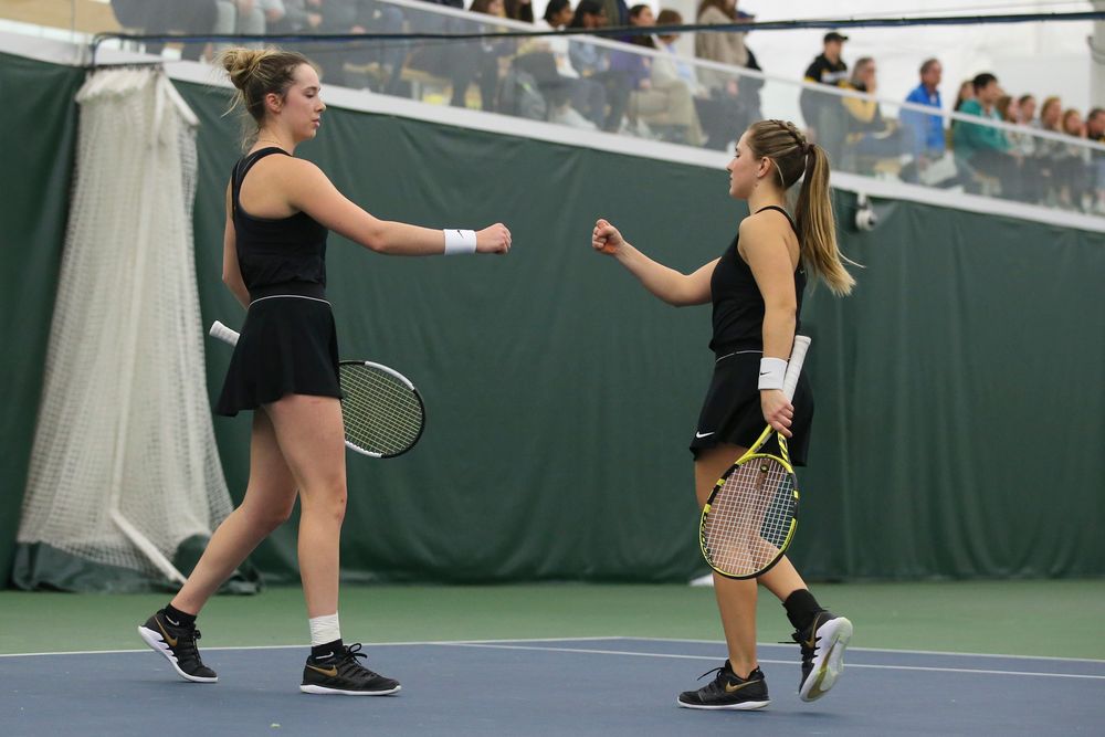 Iowa’s Samantha Mannix and Danielle Burich bump fists during doubles during the Iowa women’s tennis meet vs UNI on Saturday, February 29, 2020 at the Hawkeye Tennis and Recreation Complex. (Lily Smith/hawkeyesports.com)