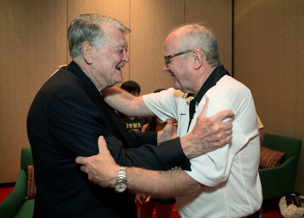 Former Hawkeye Football Head Coach Hayden Fry hugs long time athletic trainer John Streif before a panel discussion with his former quarterbacks during Fry Fest Friday, Aug. 29, 2014 in Coralville. (Brian Ray/hawkeyesports.com)