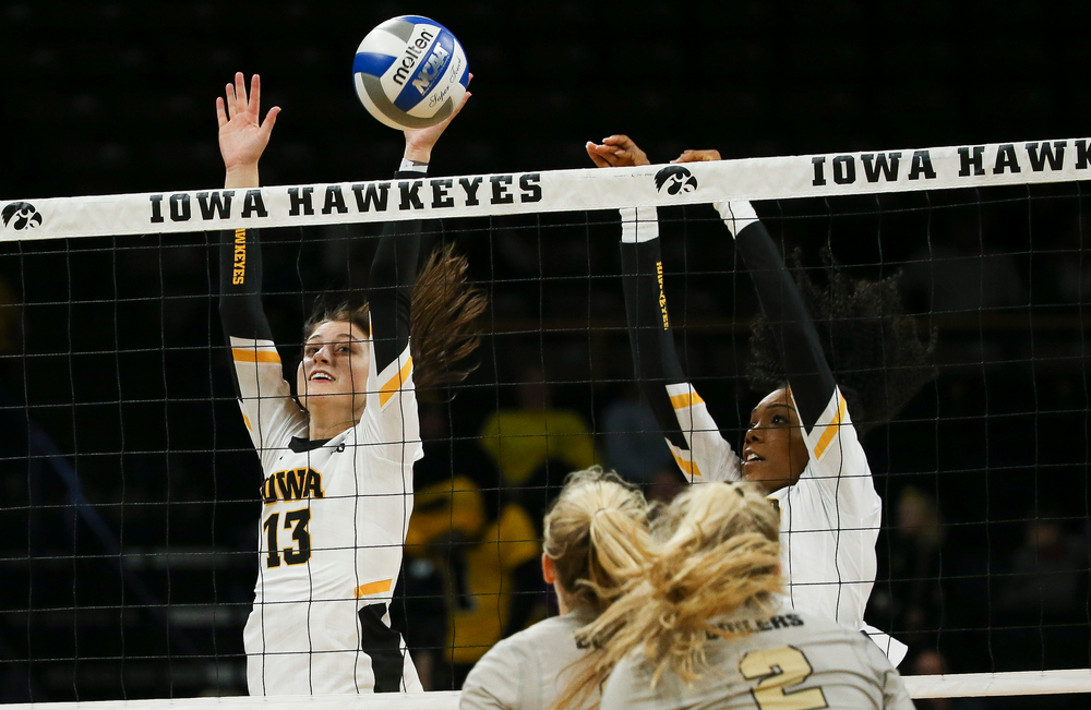 Iowa Hawkeyes middle blocker Sara Wing (13) goes up for a block during a game against Purdue at Carver-Hawkeye Arena on October 13, 2018. (Tork Mason/hawkeyesports.com)
