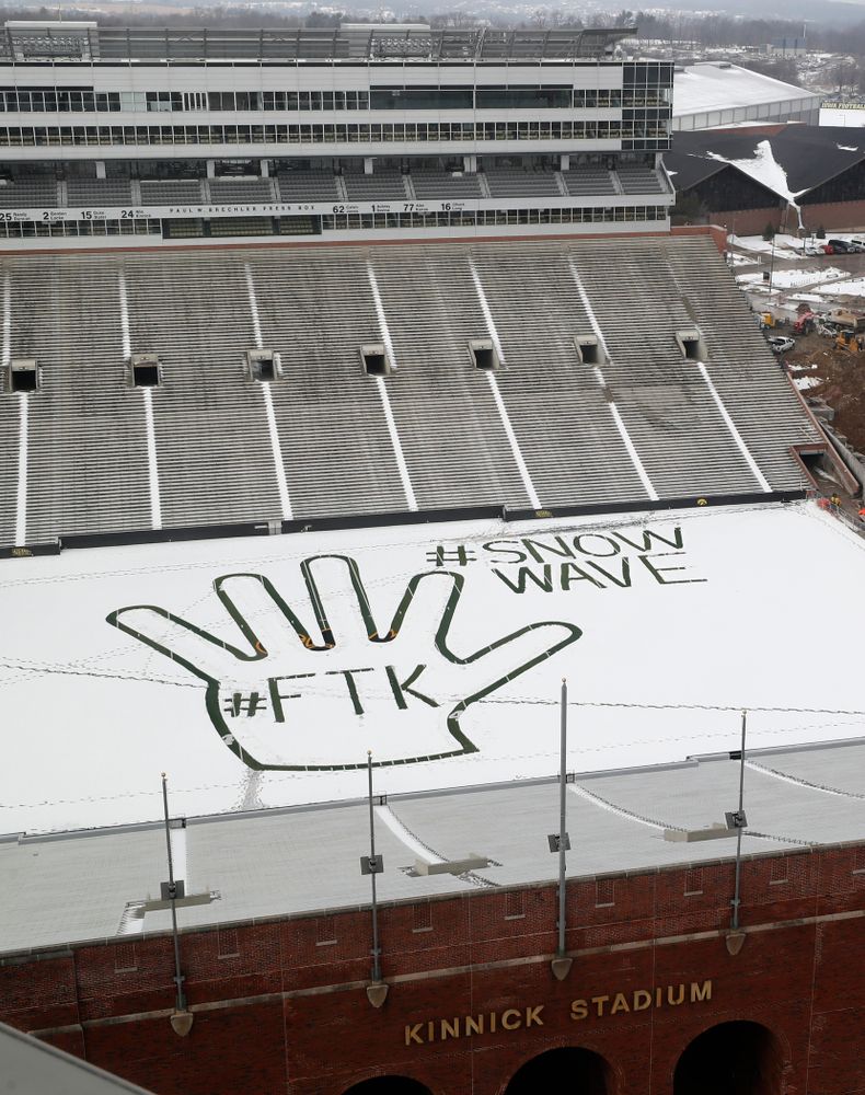Members of the Iowa Athletics Turf Management staff create the #SnowWave for kids in the Stead Family Children's Hospital Thursday, February