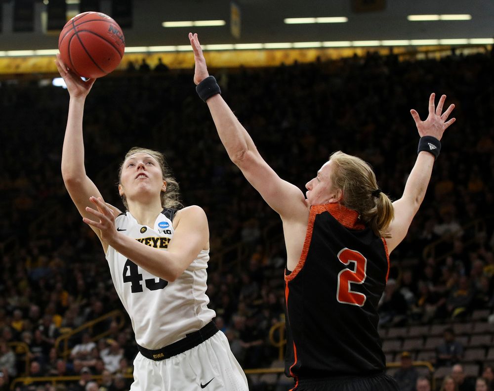 Iowa Hawkeyes forward Amanda Ollinger (43) shoots around Mercer Bears forward Amanda Thompson (2) during the first round of the 2019 NCAA Women's Basketball Tournament at Carver Hawkeye Arena in Iowa City on Friday, Mar. 22, 2019. (Stephen Mally for hawkeyesports.com)