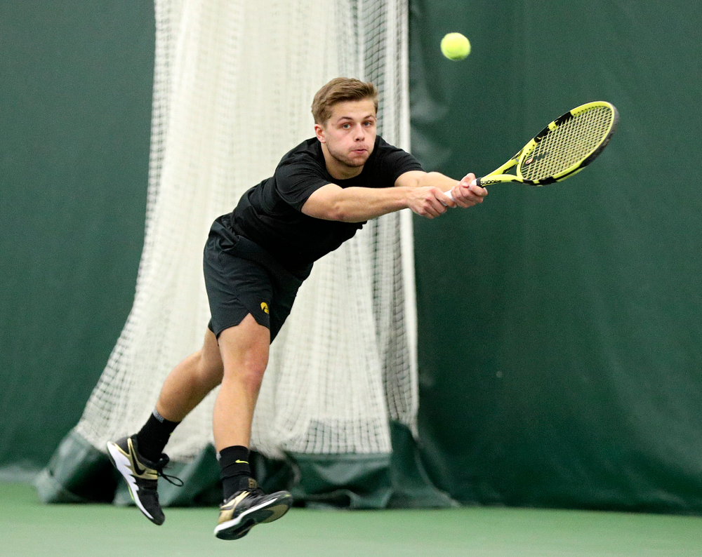 Iowa’s Will Davies reaches for a ball during his doubles match at the Hawkeye Tennis and Recreation Complex in Iowa City on Friday, February 14, 2020. (Stephen Mally/hawkeyesports.com)