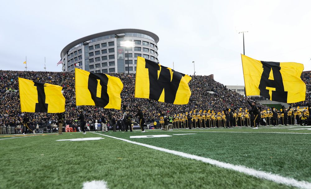 The Iowa Hawkeyes football team swarms the field before a game against Northwestern at Kinnick Stadium on November 10, 2018. (Tork Mason/hawkeyesports.com)