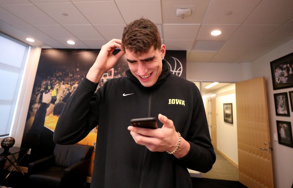 Iowa Hawkeyes forward Luka Garza (55) calls his dad after finding out that he has been named the Big Ten Player of the Year Monday, March 9, 2020 at Carver-Hawkeye Arena. (Brian Ray/hawkeyesports.com)