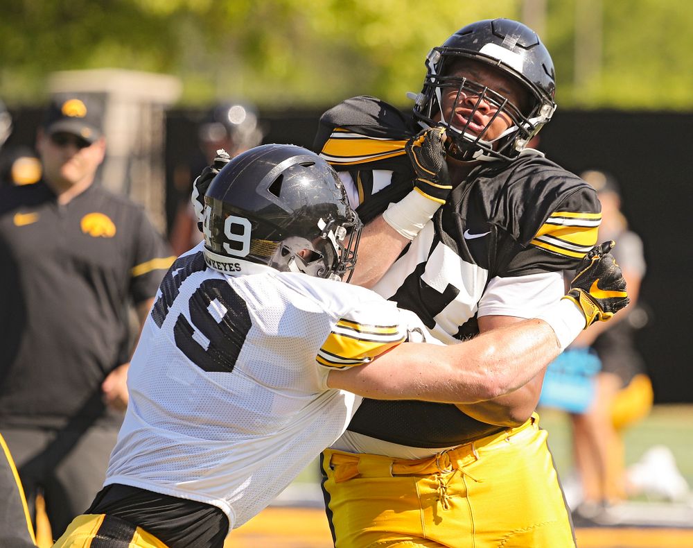 Iowa Hawkeyes linebacker Nick Niemann (49) and offensive lineman Alaric Jackson (77) run a drill during Fall Camp Practice #5 at the Hansen Football Performance Center in Iowa City on Tuesday, Aug 6, 2019. (Stephen Mally/hawkeyesports.com)