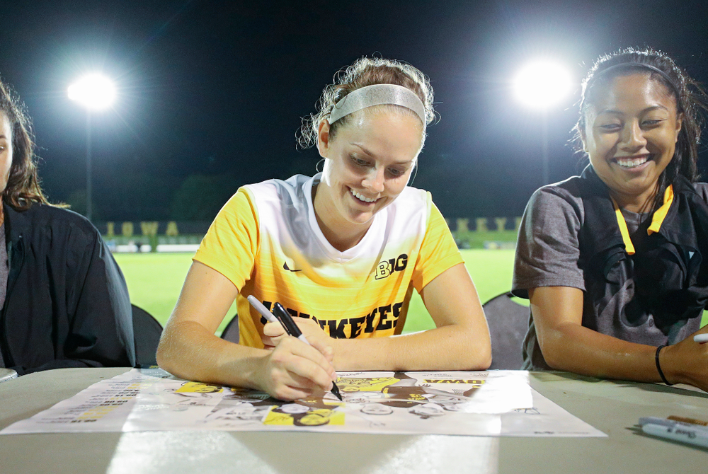 Iowa goalkeeper Claire Graves (1) signs a poster during an autograph session after their match against Western Michigan at the Iowa Soccer Complex in Iowa City on Thursday, Aug 22, 2019. (Stephen Mally/hawkeyesports.com)
