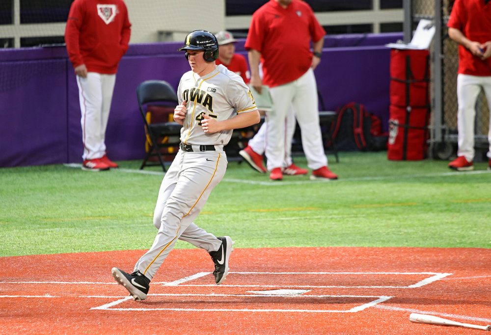 Iowa Hawkeyes first baseman Peyton Williams (45) scores a run during the fifth inning of their CambriaCollegeClassic game at U.S. Bank Stadium in Minneapolis, Minn. on Friday, February 28, 2020. (Stephen Mally/hawkeyesports.com)