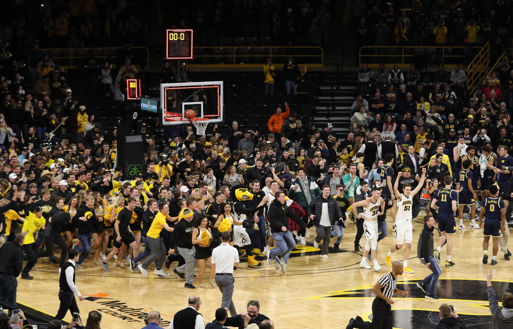 Fans storm the court after Iowa Hawkeyes defeated the Michigan Wolverines Friday, February 1, 2019 at Carver-Hawkeye Arena. (Brian Ray/hawkeyesports.com)