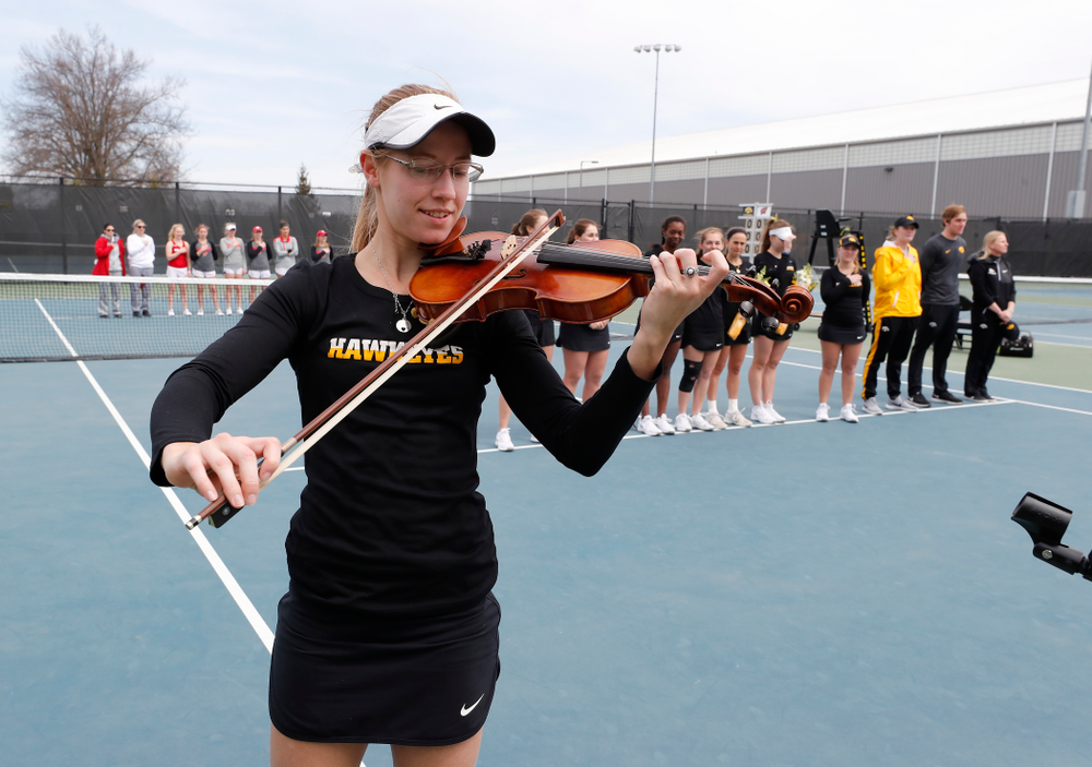 Iowa senior Montana Crawford plays the National Anthem before their match against the Wisconsin Badgers Sunday, April 22, 2018 at the Hawkeye Tennis and Recreation Center. (Brian Ray/hawkeyesports.com)