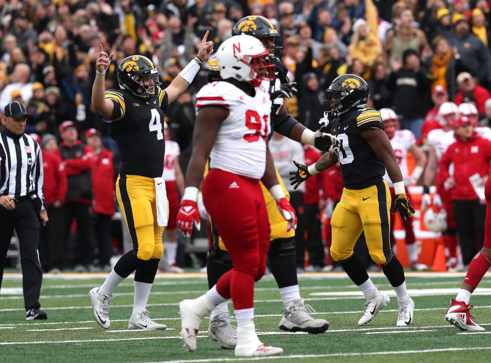 Iowa Hawkeyes quarterback Nate Stanley (4) celebrates a touchdown pass to wide receiver Brandon Smith (12) against the Nebraska Cornhuskers Friday, November 23, 2018 at Kinnick Stadium. (Brian Ray/hawkeyesports.com)