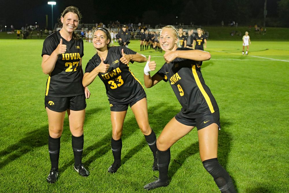 Iowa forward Samantha Tawharu (27), defender Riley Burns (33), and defender Samantha Cary (9) celebrate after their match against Western Michigan at the Iowa Soccer Complex in Iowa City on Thursday, Aug 22, 2019. (Stephen Mally/hawkeyesports.com)
