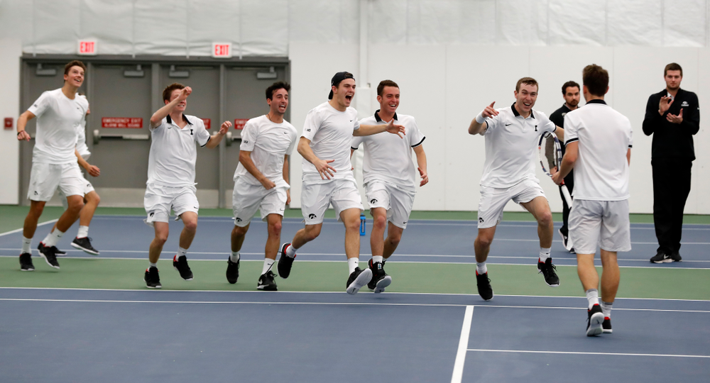 Iowa's Piotr Smietana celebrates with his teammates after clinching the match against Purdue Sunday, April 15, 2018 at the Hawkeye Tennis an