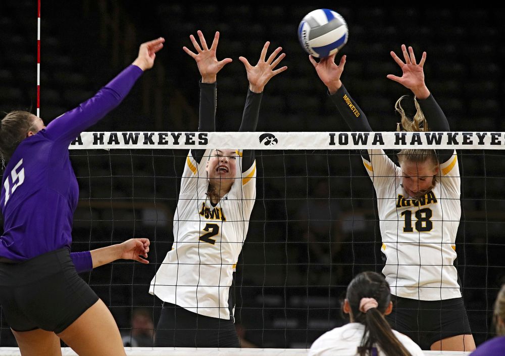 Iowa’s Hannah Clayton (18) gets her hands on a shot as Courtney Buzzerio (2) also jumps during their Big Ten/Pac-12 Challenge match at Carver-Hawkeye Arena in Iowa City on Saturday, Sep 7, 2019. (Stephen Mally/hawkeyesports.com)