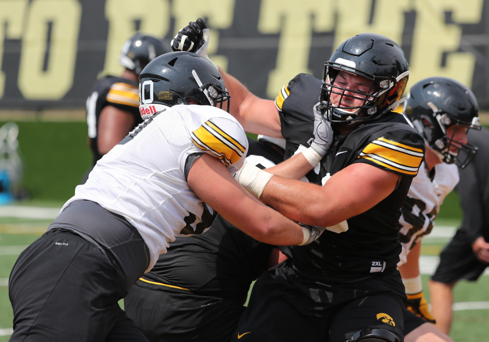 Iowa Hawkeyes offensive lineman Ross Reynolds (59) and defensive end Sam Brincks (90) during the third practice of fall camp Sunday, August 5, 2018 at the Kenyon Football Practice Facility. (Brian Ray/hawkeyesports.com)