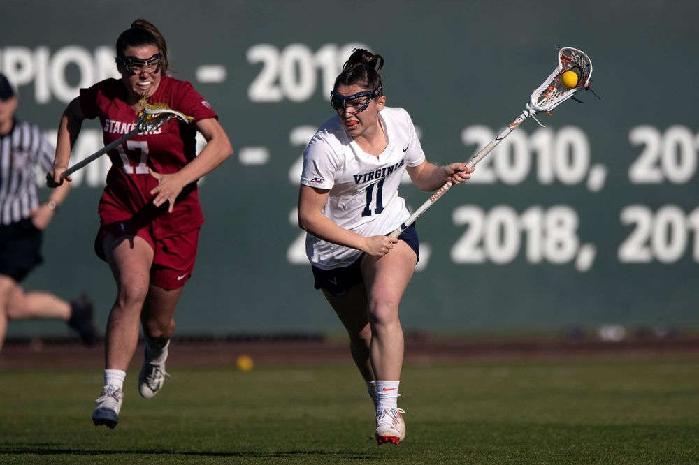 STANFORD, California - FEBRUARY 14: Virginia Cavaliers midfield Halle Graham (11) runs up field past Stanford Cardinal attack Katherine Gjertsen (17) during the first half at Cagan Stadium on February 14, 2020 in Stanford, California. The Virginia Cavaliers defeated the Stanford Cardinal 12-11. (Photo by Jason O. Watson)