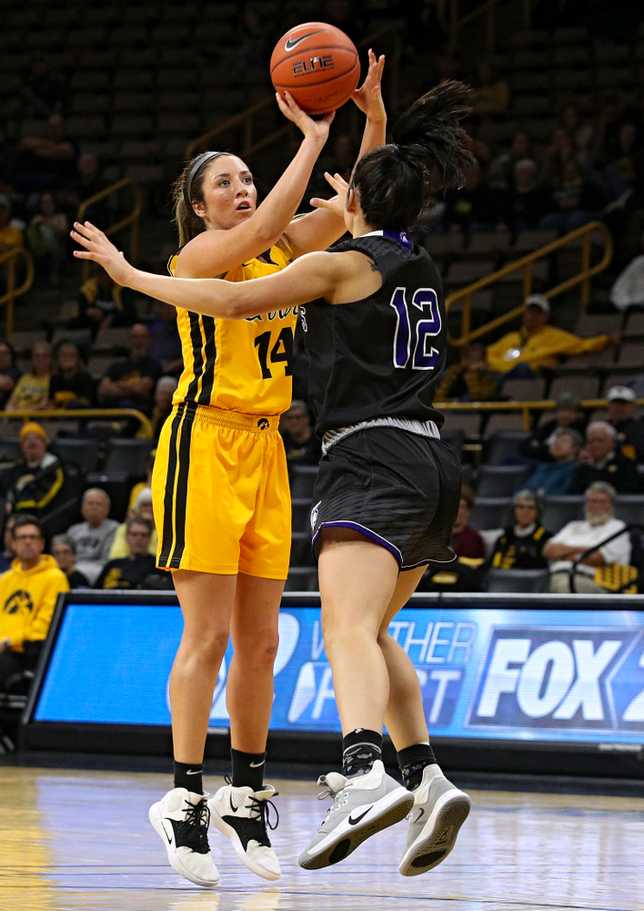 Iowa guard/forward McKenna Warnock (14) makes a basket during the second quarter of their game against Winona State at Carver-Hawkeye Arena in Iowa City on Sunday, Nov 3, 2019. (Stephen Mally/hawkeyesports.com)