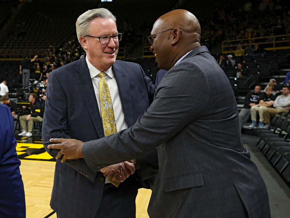 Iowa Hawkeyes head coach Fran McCaffery (from left) shakes hand with Cal Poly Mustangs head coach John Smith before their game at Carver-Hawkeye Arena in Iowa City on Sunday, Nov 24, 2019. (Stephen Mally/hawkeyesports.com)