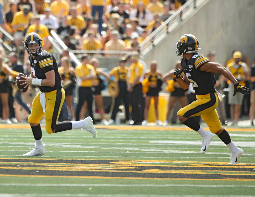 Iowa Hawkeyes quarterback Spencer Petras (7) prepares to pass to wide receiver Oliver Martin (5) during the fourth quarter of their Big Ten Conference football game at Kinnick Stadium in Iowa City on Saturday, Sep 7, 2019. (Stephen Mally/hawkeyesports.com)