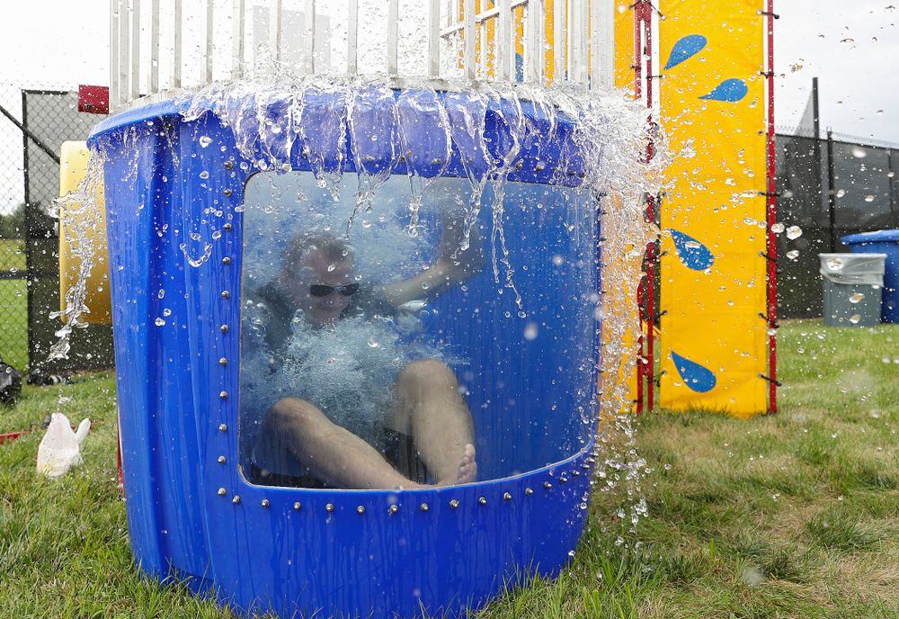 Iowa Swimming head coach Marc Long drops into the water in the dunk tank during the Student-Athlete Kickoff outside the Karro Athletics Hall of Fame Building in Iowa City on Sunday, Aug 25, 2019. (Stephen Mally/hawkeyesports.com)