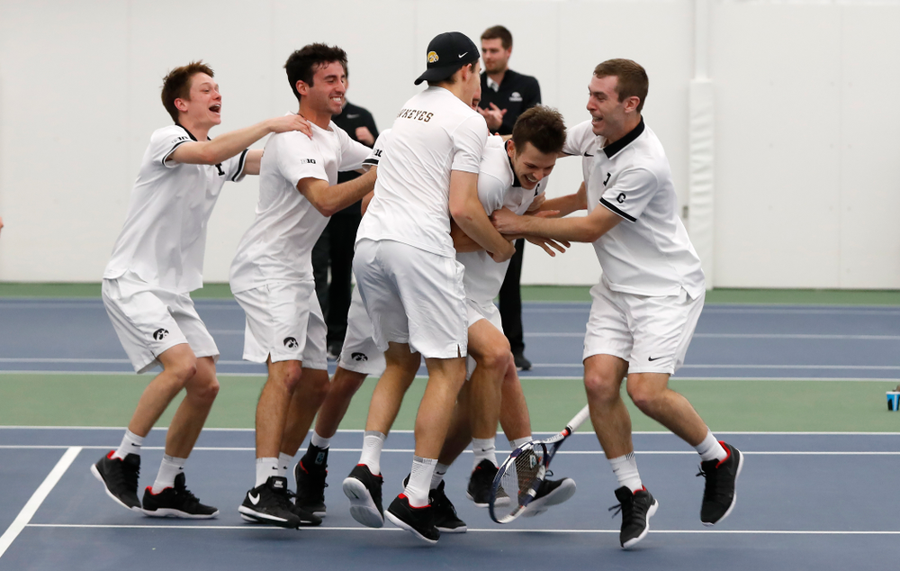 Iowa's Piotr Smietana celebrates with his teammates after clinching the match against Purdue Sunday, April 15, 2018 at the Hawkeye Tennis an