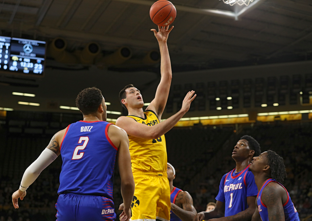 Iowa Hawkeyes forward Ryan Kriener (15) scores a basket during the first half of their game at Carver-Hawkeye Arena in Iowa City on Monday, Nov 11, 2019. (Stephen Mally/hawkeyesports.com)