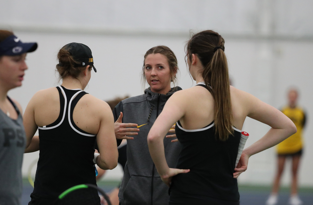 Volunteer assistant coach Cassidy Spearman talks with Samantha Mannix and Elise Van Heuvelen Treadwell as they play a doubles match against the Penn State Nittany Lions Sunday, February 24, 2019 at the Hawkeye Tennis and Recreation Complex. (Brian Ray/hawkeyesports.com)