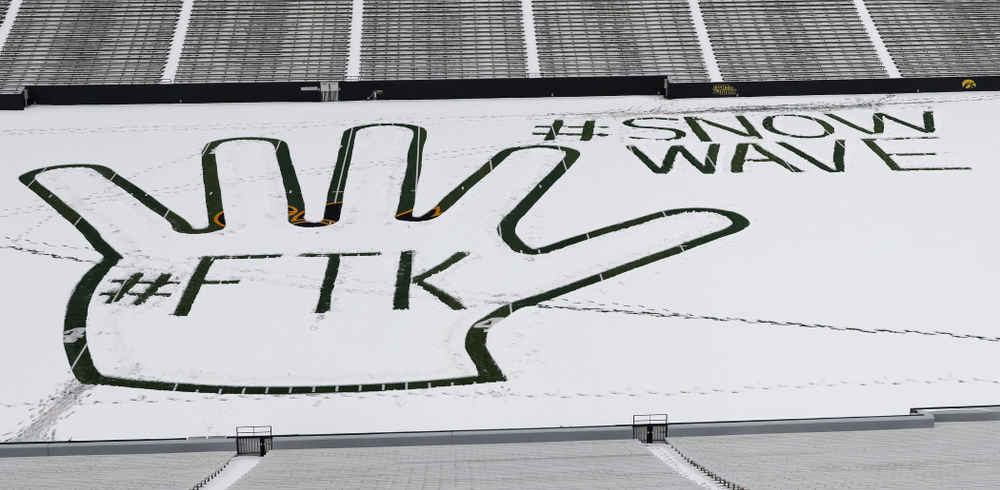 Members of the Iowa Athletics Turf Management staff create the #SnowWave for kids in the Stead Family Children's Hospital Thursday, February