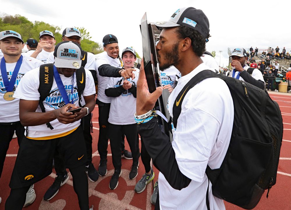 Iowa's Mar’yea Harris kisses their team trophy as he celebrates with teammates after winning the Men's Big Ten Outdoor Track and Field Championships on the third day of the Big Ten Outdoor Track and Field Championships at Francis X. Cretzmeyer Track in Iowa City on Sunday, May. 12, 2019. (Stephen Mally/hawkeyesports.com)