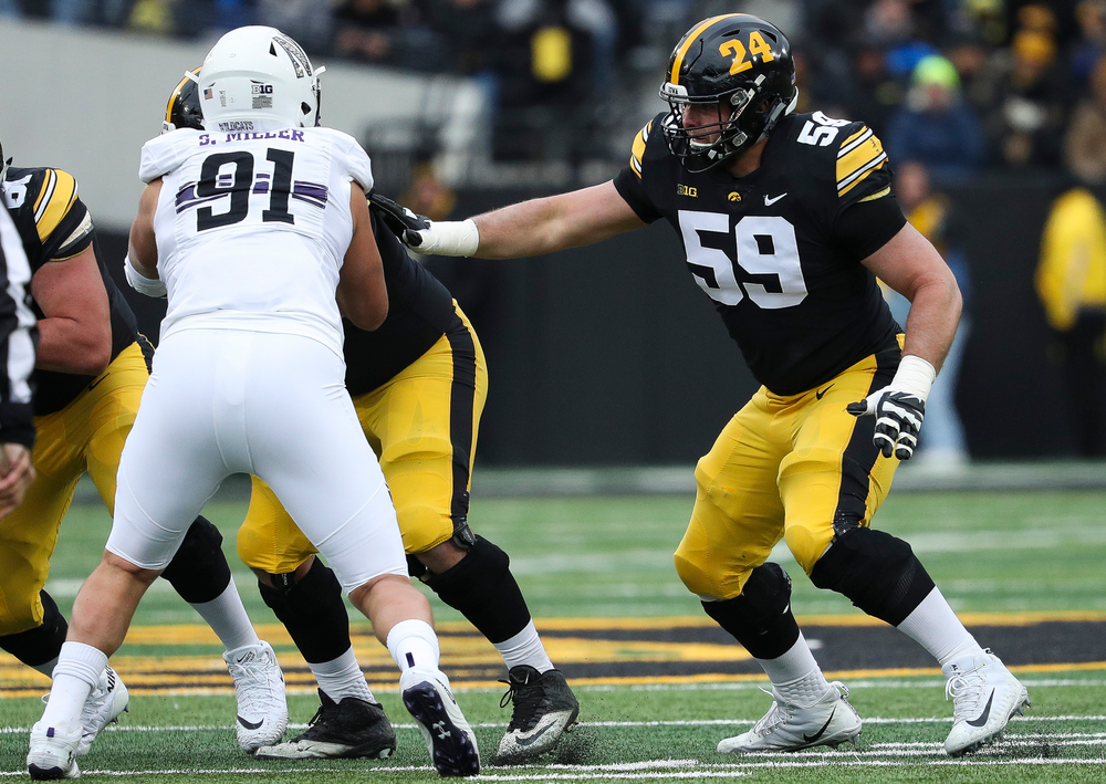 Iowa Hawkeyes offensive lineman Ross Reynolds (59) blocks during a game against Northwestern at Kinnick Stadium on November 10, 2018. (Tork Mason/hawkeyesports.com)