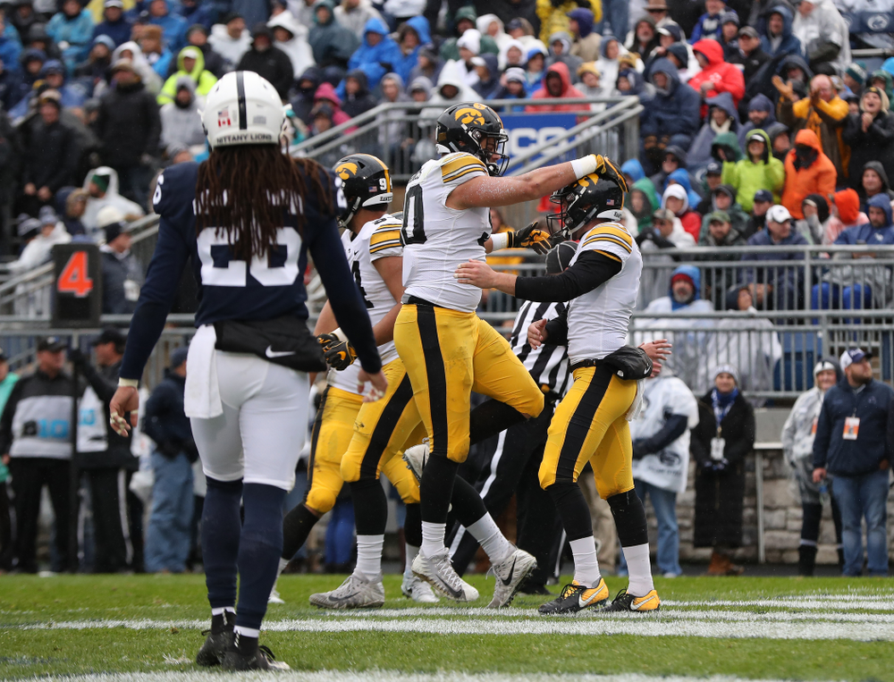 Iowa Hawkeyes defensive end Sam Brincks (90) celebrates with punter Colten Rastetter (7) catching a touchdown pass against the Penn State Nittany Lions Saturday, October 27, 2018 at Beaver Stadium in University Park, Pa. (Brian Ray/hawkeyesports.com)
