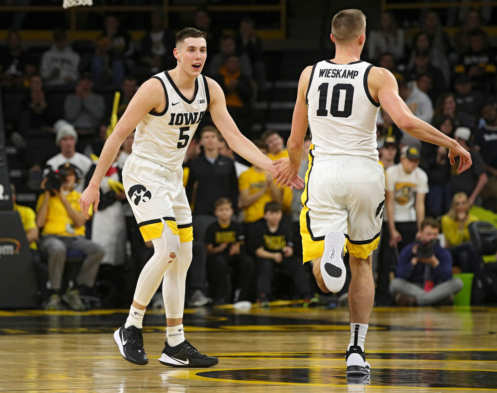 Iowa Hawkeyes guard CJ Fredrick (5) slaps hands wit guard Joe Wieskamp (10) after Wieskamp made a 3-pointer after an assist from Fredrick during the second half of their game at Carver-Hawkeye Arena in Iowa City on Friday, Nov 8, 2019. (Stephen Mally/hawkeyesports.com)