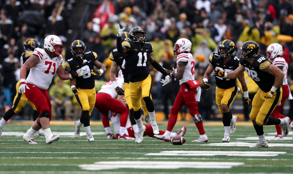 Iowa Hawkeyes defensive back Michael Ojemudia (11) celebrates after intercepting a pass against the Nebraska Cornhuskers Friday, November 23, 2018 at Kinnick Stadium. (Brian Ray/hawkeyesports.com)