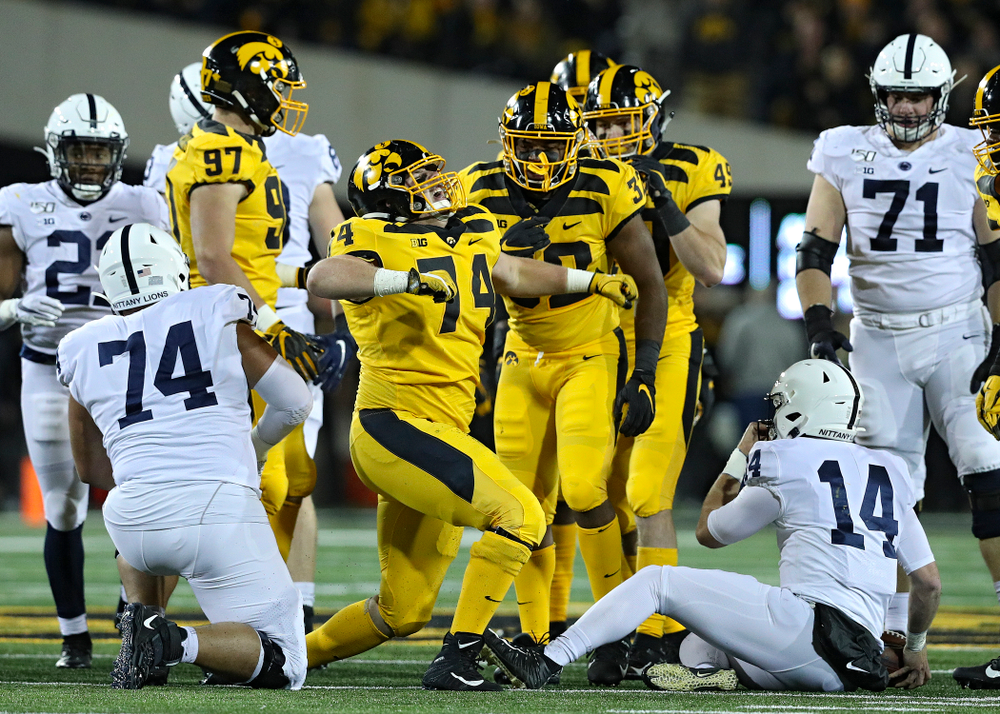 Iowa Hawkeyes defensive lineman Austin Schulte (74) celebrates after bringing down Penn State Nittany Lions quarterback Sean Clifford (14) for a loss during the first quarter of their game at Kinnick Stadium in Iowa City on Saturday, Oct 12, 2019. (Stephen Mally/hawkeyesports.com)