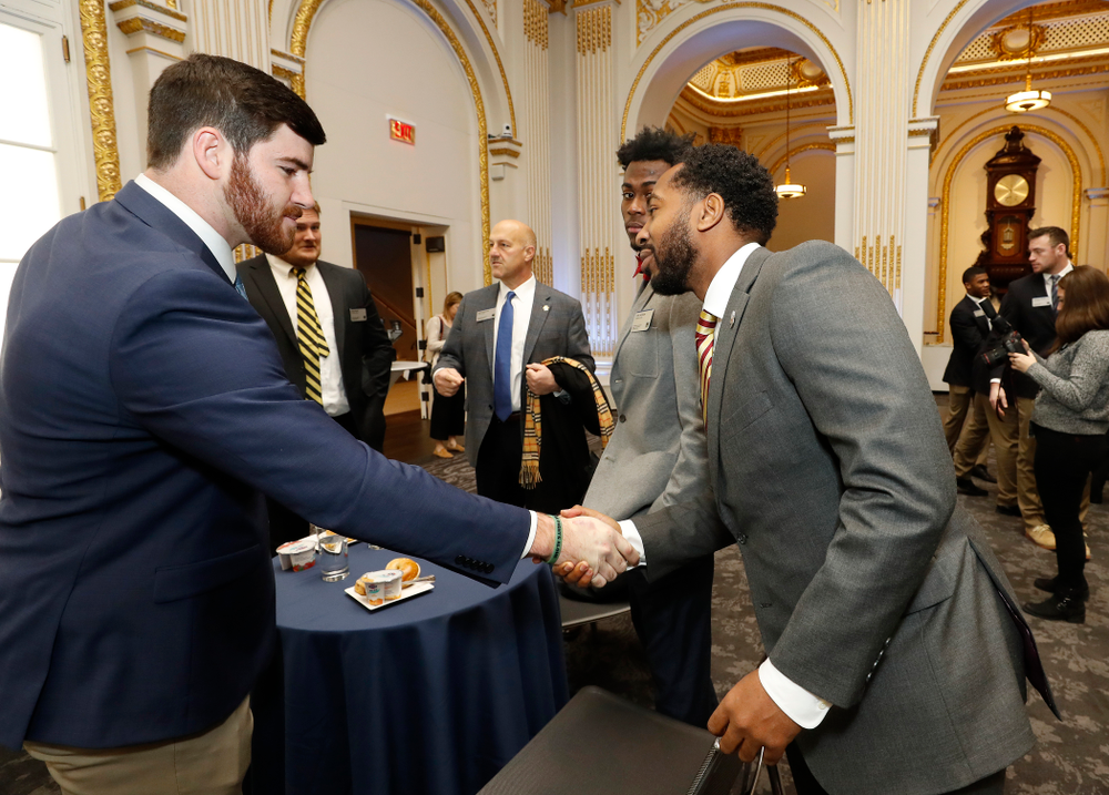 Iowa Hawkeyes linebacker Josey Jewell (43), defensive back Joshua Jackson (15), offensive lineman Sean Welsh (79) and head coach Kirk Ferentz ring the opening bell at the New York Stock Exchange Tuesday, December 26, 2017 in New York. (Brian Ray/hawkeyesports.com)