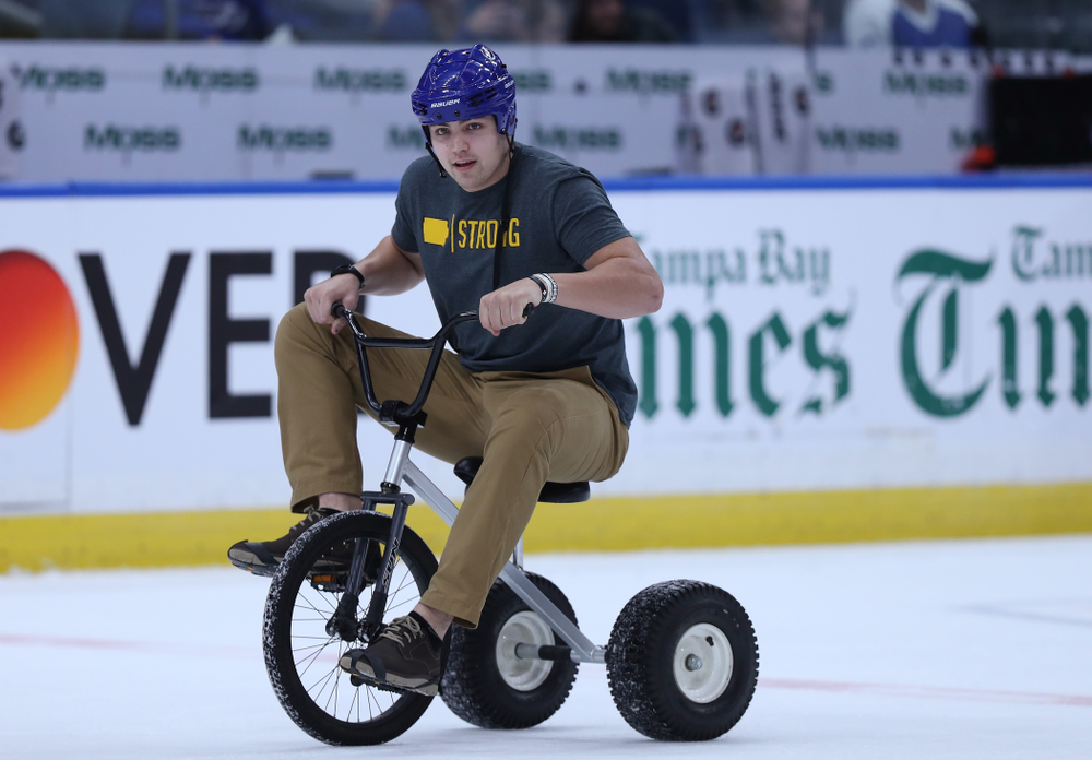 Iowa Hawkeyes quarterback Nate Stanley (4) rides a tricycle during a contest against Mississippi State during the first intermission of the Tampa Bay Lightning game Thursday, December 27, 2018 at Amalie Arena. (Brian Ray/hawkeyesports.com)
