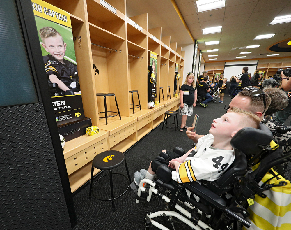 Kid Captain Cien Currie looks at his locker in the Iowa locker room during Kids Day at Kinnick Stadium in Iowa City on Saturday, Aug 10, 2019. (Stephen Mally/hawkeyesports.com)