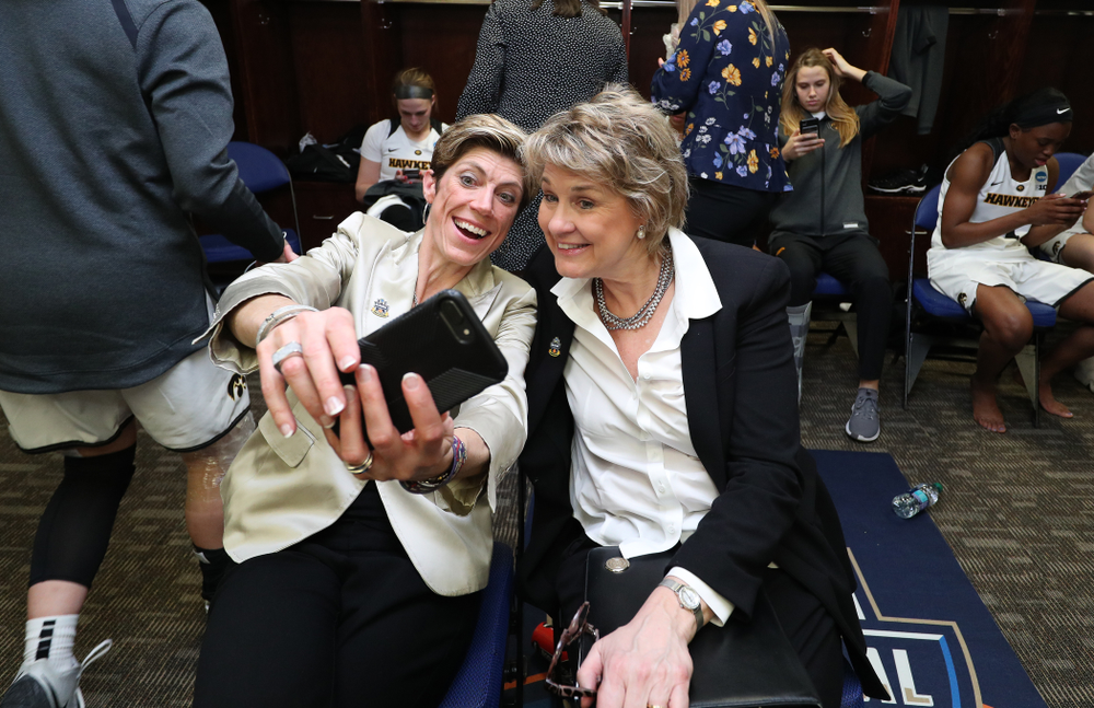 Iowa Hawkeyes head coach Lisa Bluder and associate head coach Jan Jensen take a selfie against the NC State Wolfpack in the regional semi-final of the 2019 NCAA Women's College Basketball Tournament Saturday, March 30, 2019 at Greensboro Coliseum in Greensboro, NC.(Brian Ray/hawkeyesports.com)