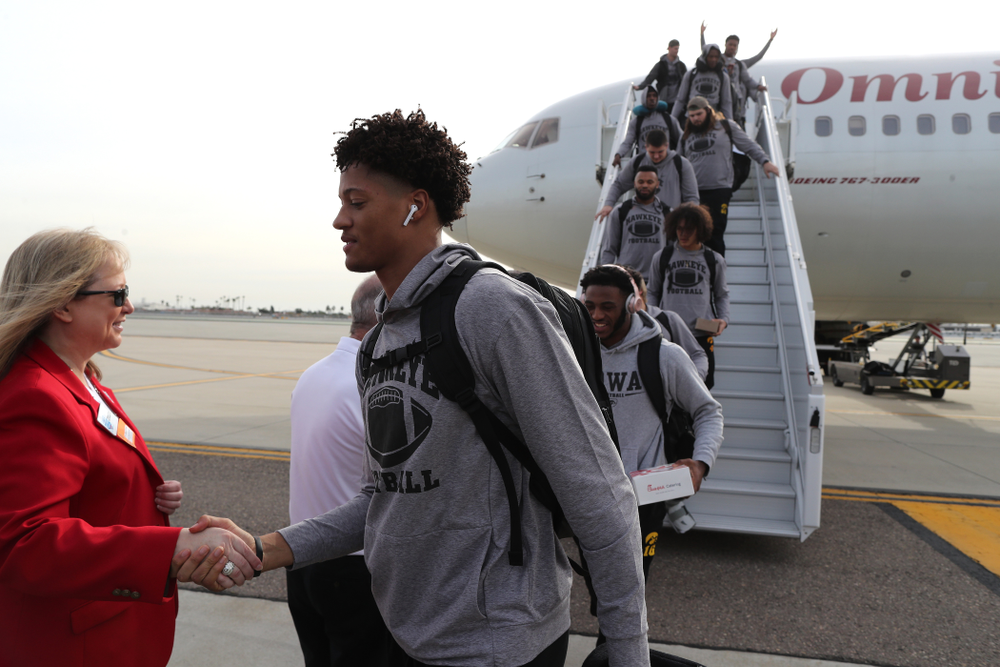 Iowa Hawkeyes defensive back Julius Brents (20) shakes hands with the ÒRed CoatsÓ after arriving in San Diego, CA Saturday, December 21, 2019 for the Holiday Bowl. (Brian Ray/hawkeyesports.com)