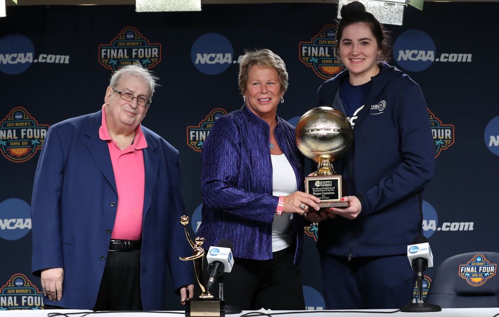 Iowa Hawkeyes forward Megan Gustafson (10) receives US Basketball Writers Association Ann Meyers Drysdale Player of the Year award from Ann Meyers Drysdale during a news conference Friday, April 5, 2019 at Amalie Arena in Tampa, FL. (Brian Ray/hawkeyesports.com)