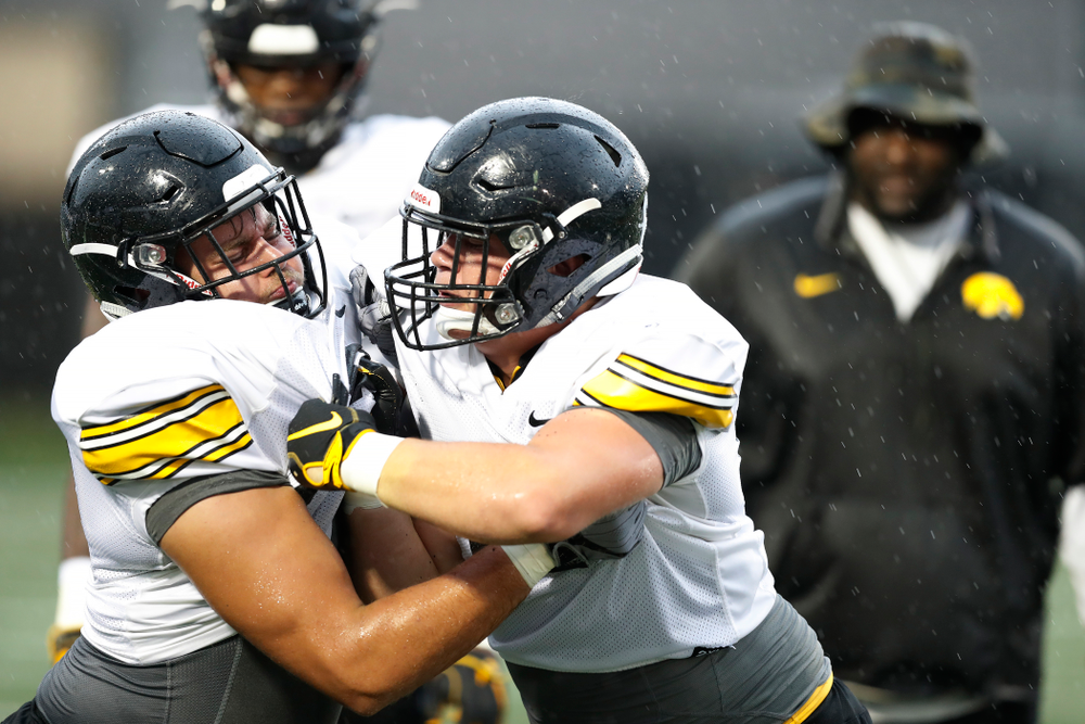 Iowa Hawkeyes defensive end Sam Brincks (90) and defensive lineman Tyler Linderbaum (65) during camp practice No. 15 Monday, August 20, 2018 at the Hansen Football Performance Center. (Brian Ray/hawkeyesports.com)
