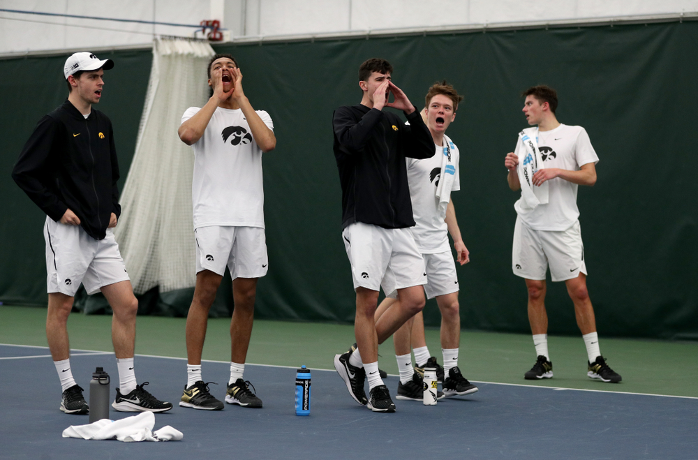 The Iowa Hawkeyes cheer on Will Davies against Cornell Sunday, March 8, 2020 at the Hawkeye Tennis and Recreation Center. (Brian Ray/hawkeyesports.com)