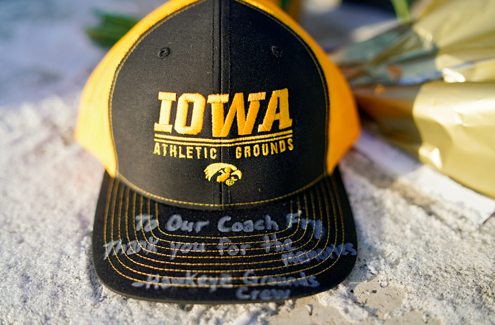 A memorial at the base of the Hayden Fry statue in Coralville on Wednesday, December 18, 2019. Hayden Fry passed away on Dec. 17, at the age of 90. (Stephen Mally/hawkeyesports.com)