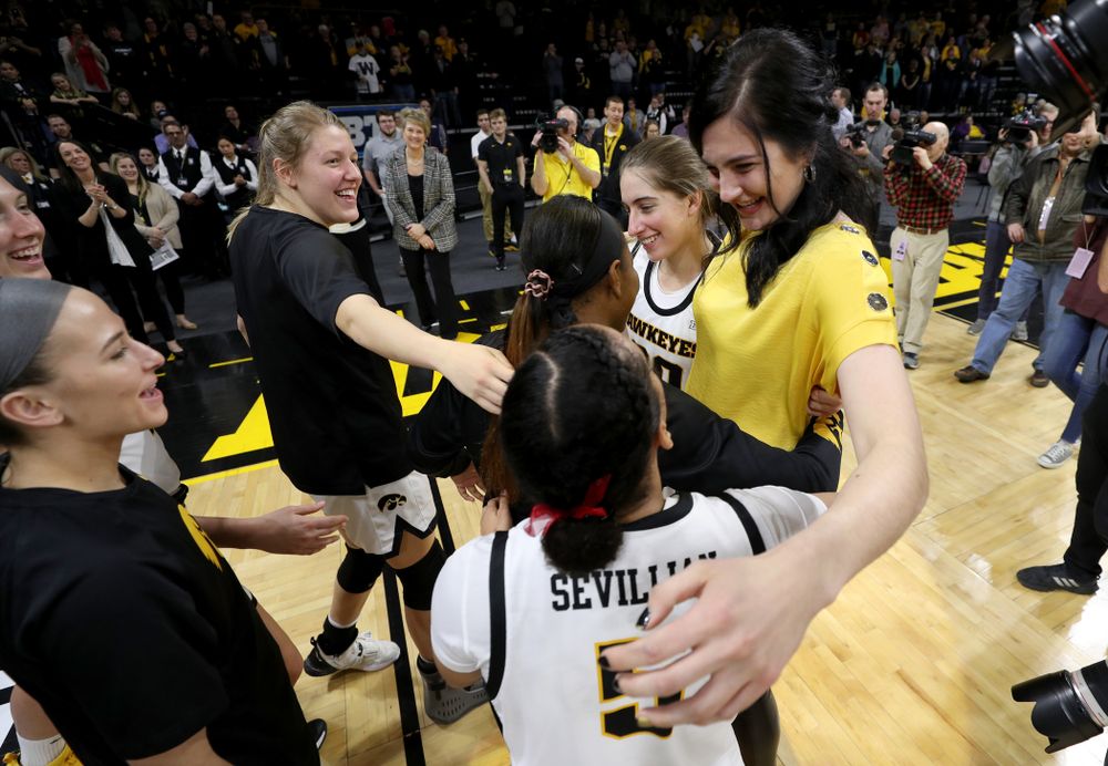Megan Gustafson hugs her teammates after her number was raised into the rafters during a jersey retirement ceremony Sunday, January 26, 2020 at Carver-Hawkeye Arena. (Brian Ray/hawkeyesports.com)